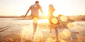 Couple Running On Beach